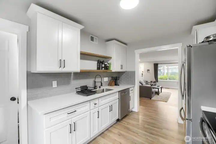 Updated white cabinets, access to laundry room