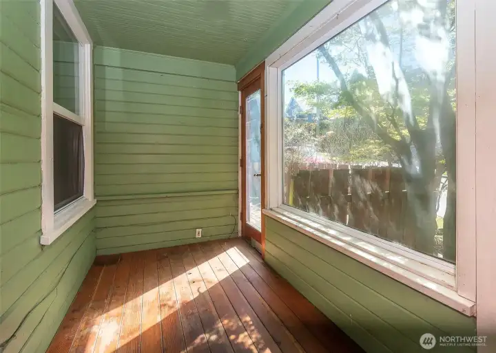 Sun filled enclosed front porch. Sun filled enclosed front porch.