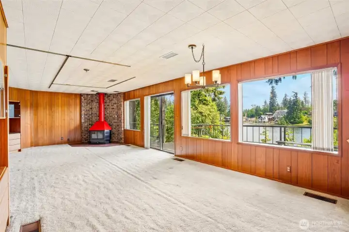 Living room with FP, built-ins, and incredible view of Lake Tapps.