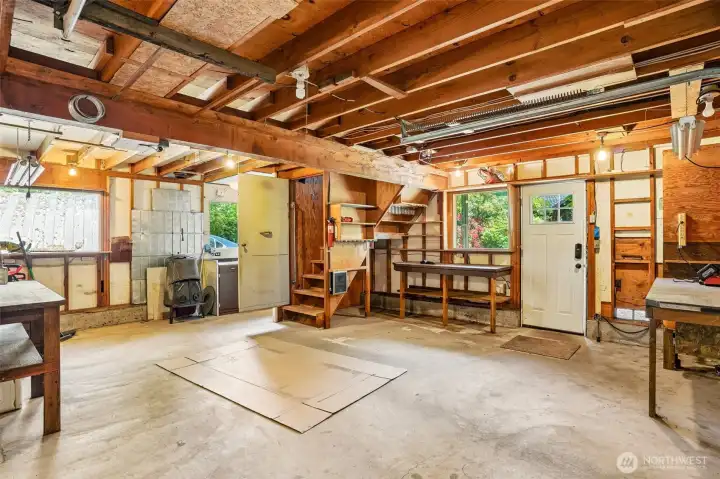 Detached garage with shop area, bathroom, and stairs to loft.