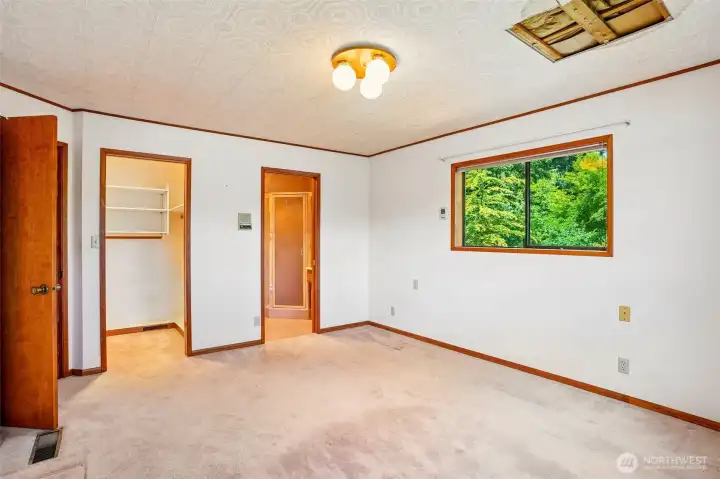 Primary suite with closet and bathroom.