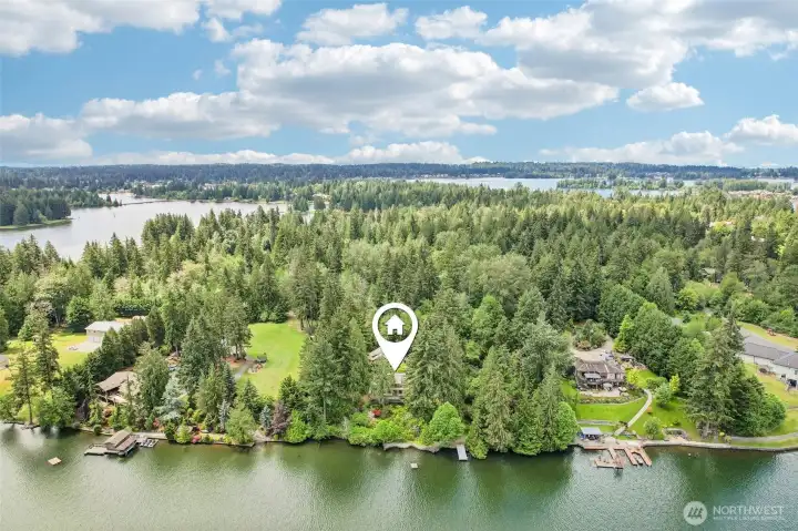 Arial view of home, garage, dock, and waterfront