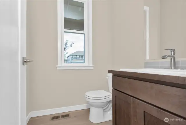 Main level half bath/powder room. Picture of similar home, not actual. Photo for illustration only.