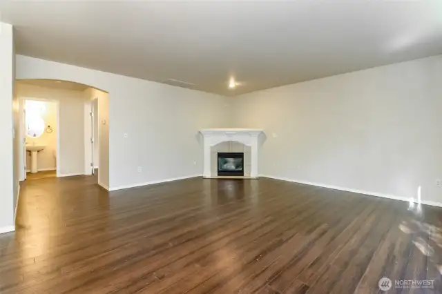 Informal Living Room Leads Right to Downstairs Half Bath and Office/Den