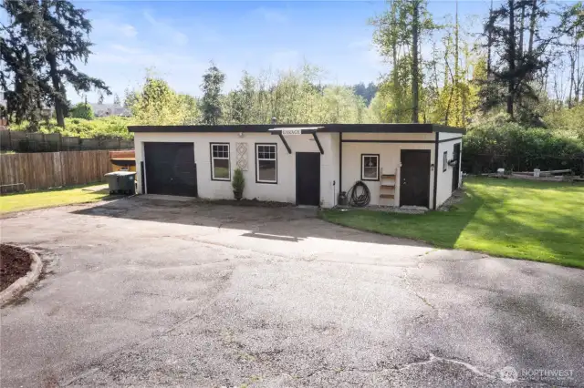 Outbuilding with one car garage and storage. Hobby room and lawn mower room