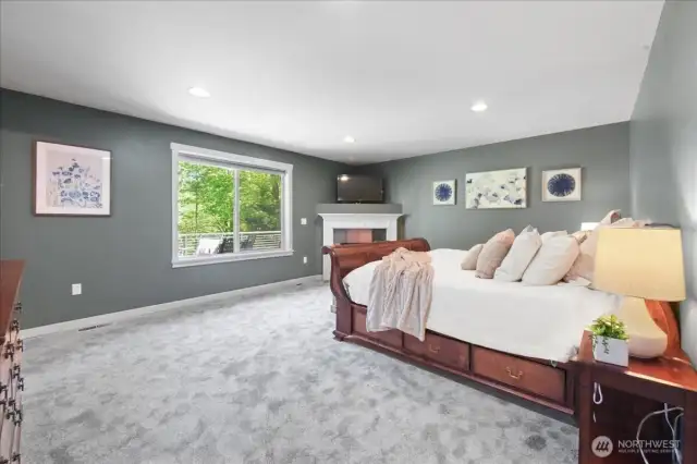 Large window overlooks deck and backyard.
