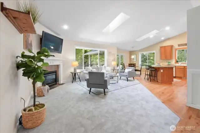 The family room is open to the kitchen and dining nook. It features new carpet, propane fireplace, vaulted ceilings and skylights.