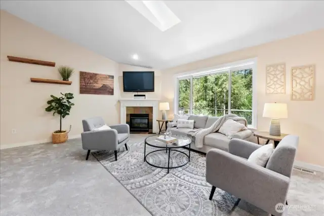 A large picture window overlooks the entertainment sized deck and backyard.