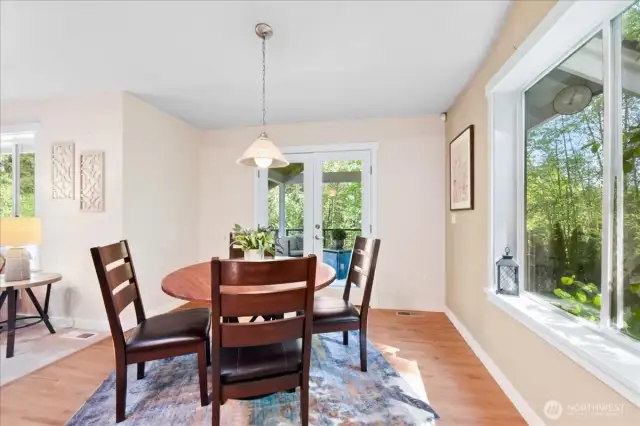 Dining nook with another large window and French doors leading to the deck.
