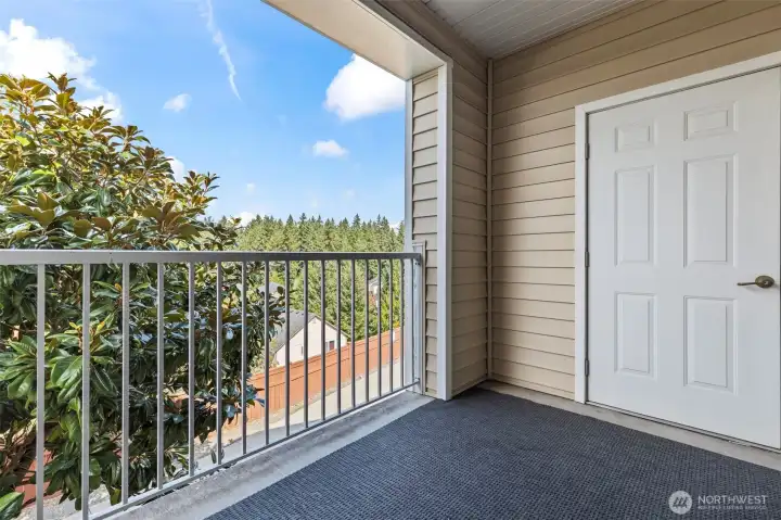 Private rear balcony is private and has a serene view of nature.  The large door is your own storage area.