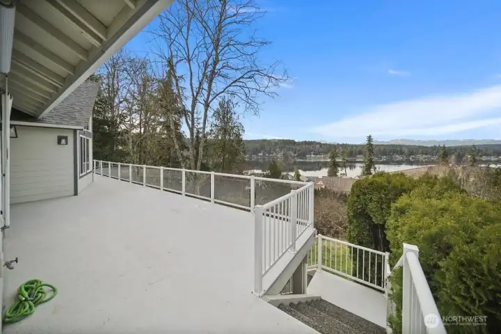Main floor deck and aggregate stairs to lower patio area.
