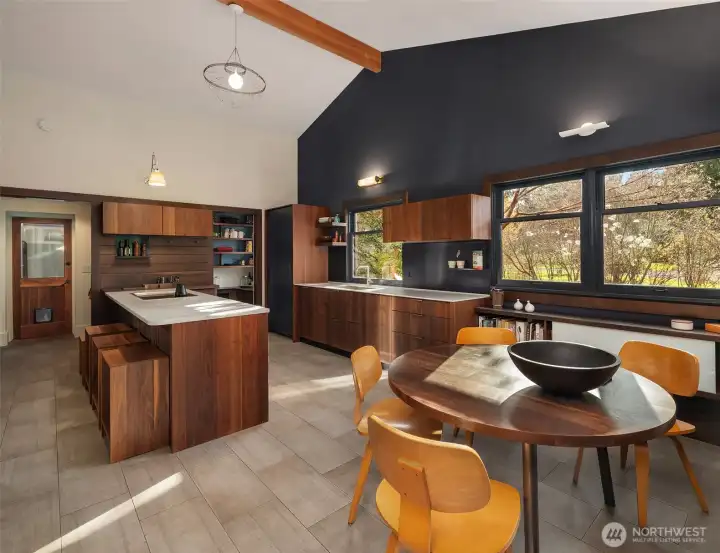 Sophisticated and understated: The kitchen is Henrybuily, marrying craft design and pragmatic innovation. Stone counter tops, rich wood cabinetry, and contrasting colors create warmth.