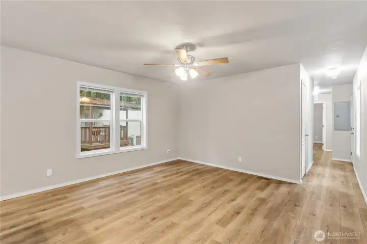 Bright open living area with large windows bringing in natural light.