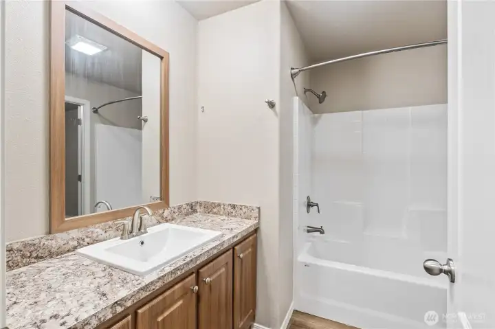 Full bathroom conveniently located between bedrooms.