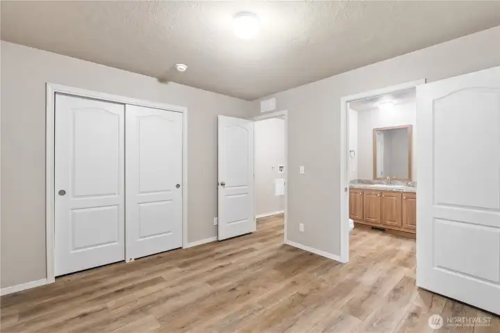 Spacious primary bedroom with convenient direct access to the full bathroom.