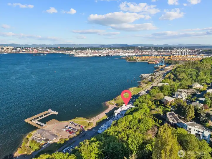 Welcome to 1661 Harbor Ave SW #502 at beautiful Point Elliott—an extraordinary waterfront residence where sweeping, unobstructed views of Puget Sound, the city skyline, and the Cascade Mountains take center stage. Perched gracefully along the shoreline, this expansive 3,426-square-foot home blends elegance, comfort, and modern convenience in one remarkable setting. Designed for both everyday living and memorable entertaining, the home features a spacious, updated chef’s kitchen equipped with high-end finishes, generous workspace, and seamless flow into the main living areas—all framed by breathtaking vistas at every turn. Floor-to-ceiling windows invite in natural light and create a constant connection to the surrounding landscape. Additional highlights include rare garage parking for four vehicles, complete with an EV charger, as well as a recently updated elevator for ease and accessibility. Every detail has been thoughtfully considered to enhance both luxury and livability.