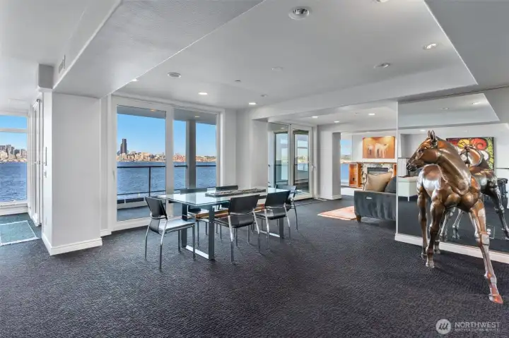 This space is ideally suited for a formal dining area, yet the versatile floor plan allows it to adapt effortlessly to your lifestyle—whether as an intimate gathering space, or an extension of the living area. Expansive sliding and tilt doors open to the generous view deck, inviting in fresh coastal air and creating a seamless indoor-outdoor flow. For added comfort, central air conditioning ensures the home remains cool and inviting even on the warmest summer days.