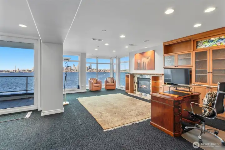 Currently configured as a home office with one of the most captivating city views in Seattle, this versatile space can easily transform into a family room, media lounge, or whatever best suits your needs. Floor-to-ceiling windows frame sweeping vistas while filling the end-unit residence with abundant natural light, creating a bright and inspiring environment throughout the day.
