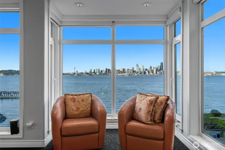 As an end-unit residence, this home enjoys additional windows along the side—complementing the expansive picture windows that span the front—filling the space with even more natural light and enhancing the sense of openness. Picture yourself here, curled up with your favorite book or unwinding with a refreshing drink at the end of the day, all while taking in the tranquil views.