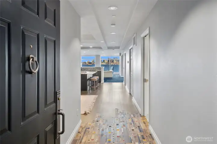 From the moment you step into this expansive 3,426-square-foot luxury residence, you are immediately greeted by breathtaking, unobstructed water and city views that command attention and set the tone for the entire home. A thoughtfully designed custom tile entry makes a striking first impression, flowing seamlessly into warm cork flooring in the kitchen that blends comfort with contemporary style. Every detail has been curated to highlight both sophistication and livability in this exceptional waterside retreat.