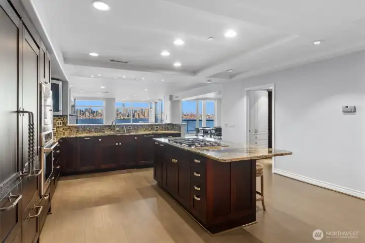 In this wide-open kitchen, even the most routine moments are elevated into something special, where preparing meals or brewing a simple cup of coffee becomes a true pleasure. Surrounded by sweeping, unobstructed views, the space transforms everyday tasks into a serene and inspiring experience. In this view, you’ll also notice the convenient opening to the butler’s pantry on the right.