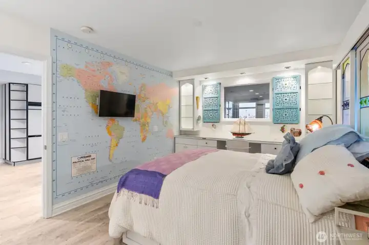 One of the three bedrooms features a beautifully designed built-in and a window that frames a view of Seattle, bringing the city right into the space.