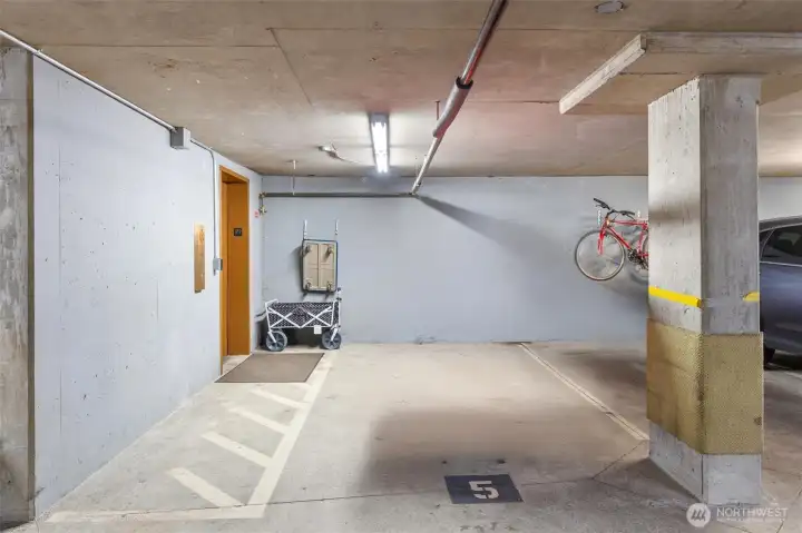 This condominium includes FOUR dedicated garage parking spaces—a rare and highly desirable feature. Space #5 is conveniently located just outside the elevator, making grocery unloading and everyday access effortless. The next image showcases three contiguous parking stalls, equipped with EV charging for added convenience and modern living.