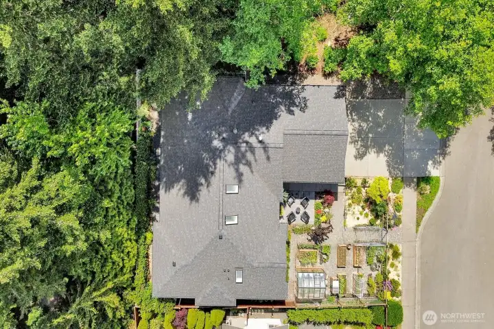 Great aerial shot straight overhead showcasing this wonderful lot surrounded on 3 sides by beautiful NW Fir trees and great fenced master garden