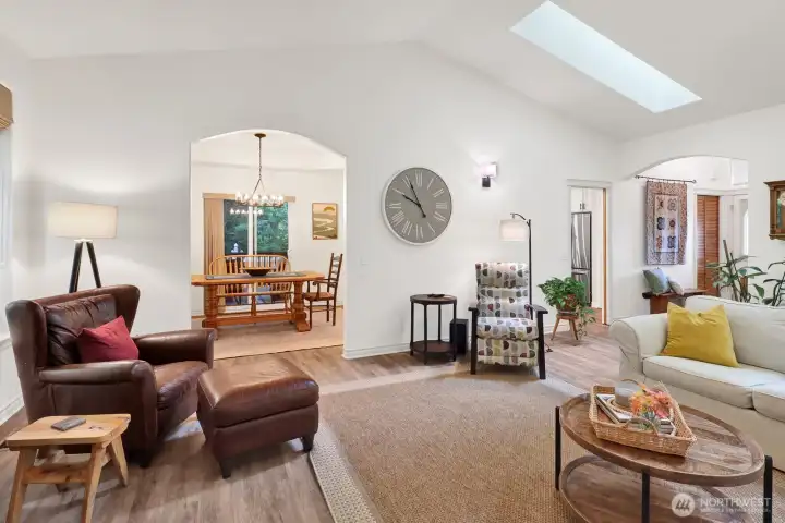 Another view of living room looking into formal dining area. Vaulted ceiling with new skylights let in wonderful natural light.