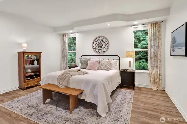 Large primary bedroom with attached bath , reading lights and nature just outside your windows.
