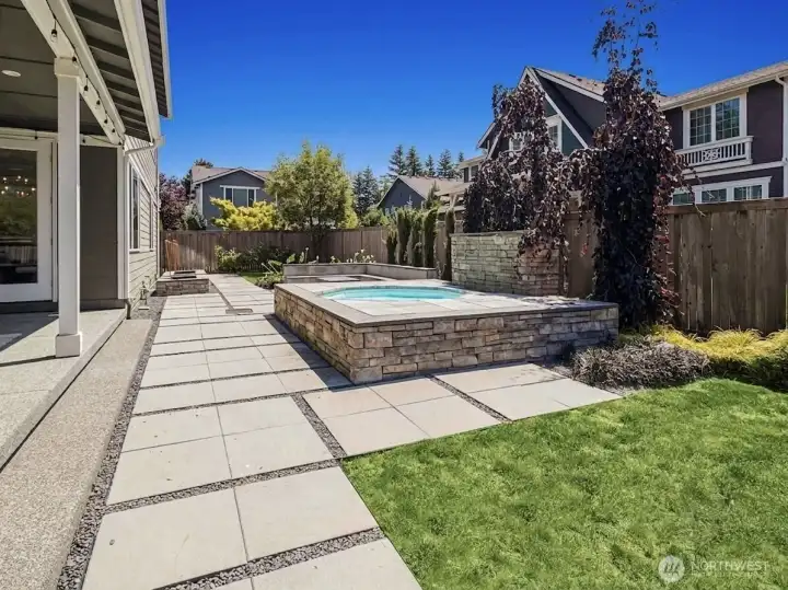 raised garden beds, built in gas outdoor fireplace with a low maintenance yard