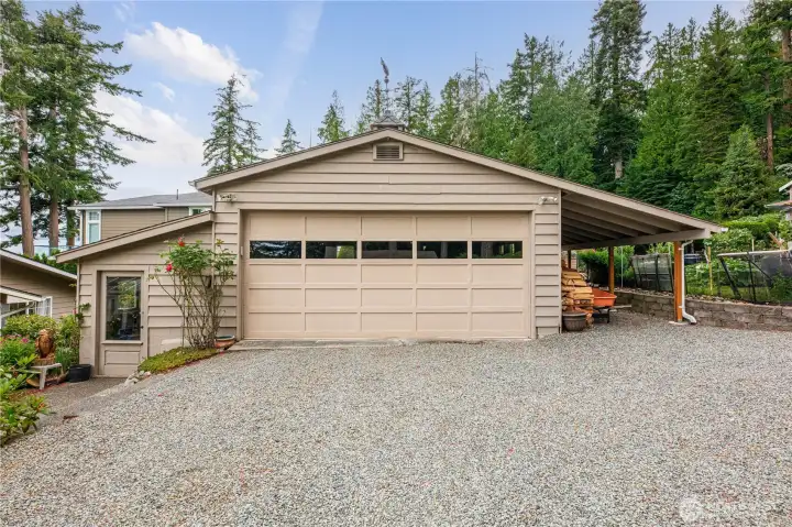 2 car garage with covered space for wood.