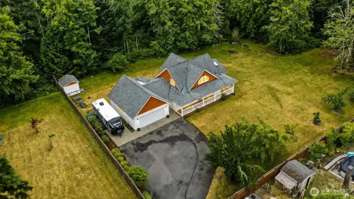 A property that lives like a private retreat, embraced by towering evergreens and surrounded by the peaceful beauty of nature. Gracefully positioned at the heart of 2.26 park-like acres, the home showcases timeless architecture, an inviting wraparound covered deck, and expansive grounds that create an unforgettable first impression. The landscape is more than beautiful—it is productive and enduring, featuring mature apple, pear, plum, and Asian pear trees, along with thriving blueberry bushes that add seasonal beauty and the simple pleasure of harvesting from your own backyard. With room for RV parking, outdoor entertaining, gardening, evenings around the fire pit, and potential space for a future shop or ADU (buyer to verify), this exceptional property offers a rare blend of privacy, natural beauty, versatility, and the quintessential Pacific Northwest lifestyle. A property that lives like a private retreat, embraced by towering evergreens and surrounded by the peaceful beauty of nature. Gracefully positioned at the heart of 2.26 park-like acres, the home showcases timeless architecture, an inviting wraparound covered deck, and expansive grounds that create an unforgettable first impression. The landscape is more than beautiful—it is productive and enduring, featuring mature apple, pear, plum, and Asian pear trees, along with thriving blueberry bushes that add seasonal beauty and the simple pleasure of harvesting from your own backyard. With room for RV parking, outdoor entertaining, gardening, evenings around the fire pit, and potential space for a future shop or ADU (buyer to verify), this exceptional property offers a rare blend of privacy, natural beauty, versatility, and the quintessential Pacific Northwest lifestyle.