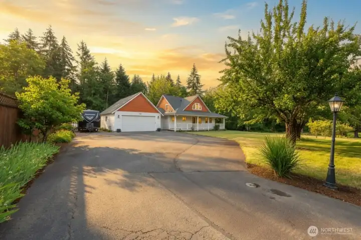 Bathed in the warm glow of the evening sun, this extraordinary home radiates timeless elegance and irresistible curb appeal. The expansive driveway, welcoming wraparound porch, and beautifully landscaped grounds create a grand arrival, while towering evergreens and open park-like lawns provide exceptional privacy and a tranquil setting that feels miles away from the ordinary. Bathed in the warm glow of the evening sun, this extraordinary home radiates timeless elegance and irresistible curb appeal. The expansive driveway, welcoming wraparound porch, and beautifully landscaped grounds create a grand arrival, while towering evergreens and open park-like lawns provide exceptional privacy and a tranquil setting that feels miles away from the ordinary.