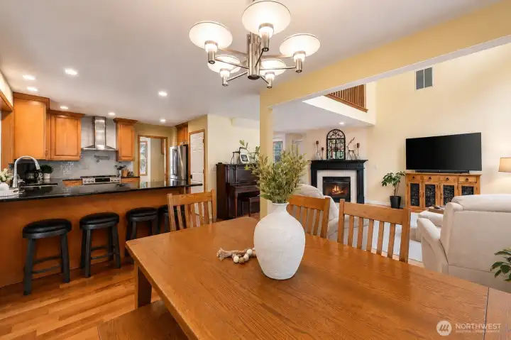 This warm and inviting dining area flows seamlessly into the beautifully appointed kitchen, creating the perfect setting for everyday living and effortless entertaining. Rich hardwood floors, abundant natural light, and large windows frame peaceful backyard views, while the kitchen offers a generous island with seating, wood cabinetry, stainless appliances, stylish hood, pot filler, and plenty of workspace. The open layout connects indoor comfort with the outdoor living area, making this space feel both functional and welcoming. This warm and inviting dining area flows seamlessly into the beautifully appointed kitchen, creating the perfect setting for everyday living and effortless entertaining. Rich hardwood floors, abundant natural light, and large windows frame peaceful backyard views, while the kitchen offers a generous island with seating, wood cabinetry, stainless appliances, stylish hood, pot filler, and plenty of workspace. The open layout connects indoor comfort with the outdoor living area, making this space feel both functional and welcoming.