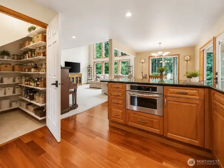A dream for home chefs and entertainers alike, the expansive walk-in pantry offers abundant shelving and exceptional storage for pantry staples, small appliances, and serving essentials. Thoughtfully designed to keep everything beautifully organized and within easy reach, it complements the chef-inspired kitchen while enhancing the home's seamless flow and everyday functionality. A dream for home chefs and entertainers alike, the expansive walk-in pantry offers abundant shelving and exceptional storage for pantry staples, small appliances, and serving essentials. Thoughtfully designed to keep everything beautifully organized and within easy reach, it complements the chef-inspired kitchen while enhancing the home's seamless flow and everyday functionality.