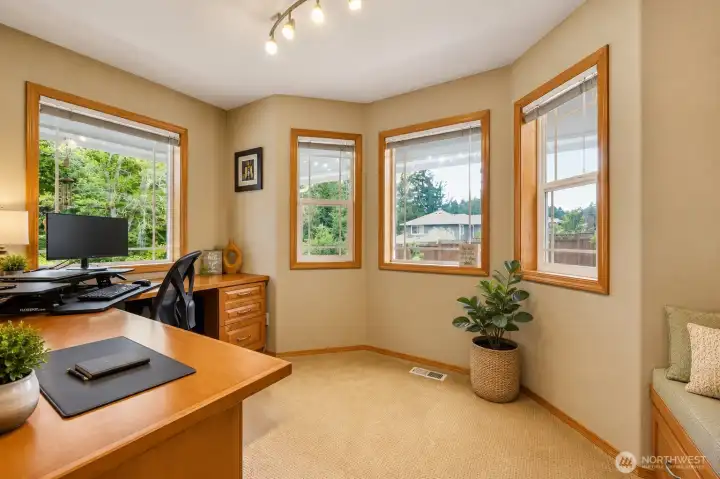 This light-filled space offers wonderful flexibility as a home office, reading room, or study, enhanced by multiple windows that bring in abundant natural light and peaceful views. Warm wood trim and neutral tones create an inviting atmosphere, while the built-in bench adds both charm and function—perfect for a cozy seating nook, extra storage, or a quiet place to relax. This room is ideal for working from home or enjoying a comfortable retreat. This light-filled space offers wonderful flexibility as a home office, reading room, or study, enhanced by multiple windows that bring in abundant natural light and peaceful views. Warm wood trim and neutral tones create an inviting atmosphere, while the built-in bench adds both charm and function—perfect for a cozy seating nook, extra storage, or a quiet place to relax. This room is ideal for working from home or enjoying a comfortable retreat.