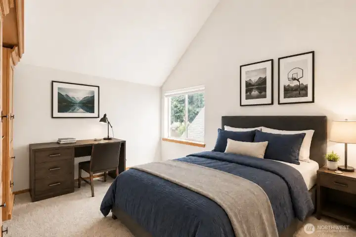 Bright and cheerful bedroom featuring a vaulted ceiling and an abundance of natural light. The fresh color palette and thoughtful layout make this room feel open, inviting, and highly functional. Bright and cheerful bedroom featuring a vaulted ceiling and an abundance of natural light. The fresh color palette and thoughtful layout make this room feel open, inviting, and highly functional.