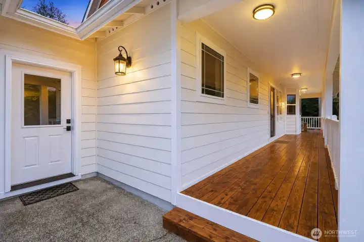 The beautifully refinished wraparound covered deck serves as a seamless extension of the home, offering an inviting outdoor retreat for year-round living and entertaining. Surrounded by the peaceful beauty of the park-like setting, it's the perfect place to enjoy morning coffee, afternoon gatherings, or quiet evenings. A convenient private entrance to the mudroom enhances everyday functionality, while motion-activated lighting adds both elegance and convenience after sunset. The beautifully refinished wraparound covered deck serves as a seamless extension of the home, offering an inviting outdoor retreat for year-round living and entertaining. Surrounded by the peaceful beauty of the park-like setting, it's the perfect place to enjoy morning coffee, afternoon gatherings, or quiet evenings. A convenient private entrance to the mudroom enhances everyday functionality, while motion-activated lighting adds both elegance and convenience after sunset.