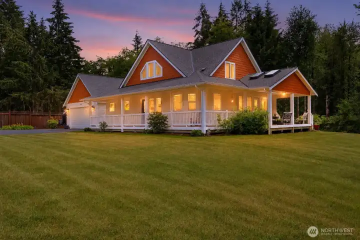 As the evening sky is painted in brilliant shades of gold and rose, this extraordinary home becomes a true Northwest masterpiece. Warm light spills from every window, the wraparound covered porch invites quiet conversation, and the surrounding evergreens create an atmosphere of complete privacy and serenity. It's a setting that feels both grand and welcoming—a place where unforgettable memories begin. As the evening sky is painted in brilliant shades of gold and rose, this extraordinary home becomes a true Northwest masterpiece. Warm light spills from every window, the wraparound covered porch invites quiet conversation, and the surrounding evergreens create an atmosphere of complete privacy and serenity. It's a setting that feels both grand and welcoming—a place where unforgettable memories begin.