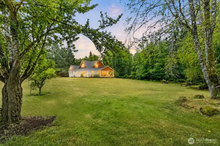 Nestled within a breathtaking park-like landscape, this exceptional property offers over 2.26 acres of privacy, open lawn, and towering evergreens that create your own secluded Northwest retreat. Framed by mature fruit trees and lush natural beauty, the home sits gracefully in the distance, showcasing its expansive wraparound porch and seamless connection to the surrounding landscape. A setting this peaceful is rarely found—where nature, space, and serenity become part of everyday living. Nestled within a breathtaking park-like landscape, this exceptional property offers over 2.26 acres of privacy, open lawn, and towering evergreens that create your own secluded Northwest retreat. Framed by mature fruit trees and lush natural beauty, the home sits gracefully in the distance, showcasing its expansive wraparound porch and seamless connection to the surrounding landscape. A setting this peaceful is rarely found—where nature, space, and serenity become part of everyday living.