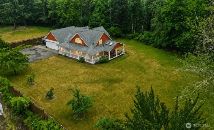 A breathtaking aerial perspective reveals the rare beauty of this private Northwest retreat. Gracefully positioned at the heart of 2.26 park-like acres, the home is surrounded by majestic evergreens, creating a secluded sanctuary where nature and everyday living exist in perfect harmony. Expansive, usable grounds offer exceptional versatility while preserving the peaceful character of the landscape. A breathtaking aerial perspective reveals the rare beauty of this private Northwest retreat. Gracefully positioned at the heart of 2.26 park-like acres, the home is surrounded by majestic evergreens, creating a secluded sanctuary where nature and everyday living exist in perfect harmony. Expansive, usable grounds offer exceptional versatility while preserving the peaceful character of the landscape.