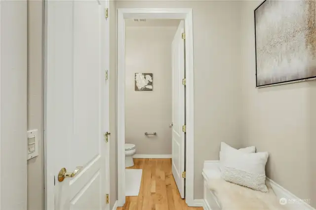 convenient entry bench and closet leads to the powder room.