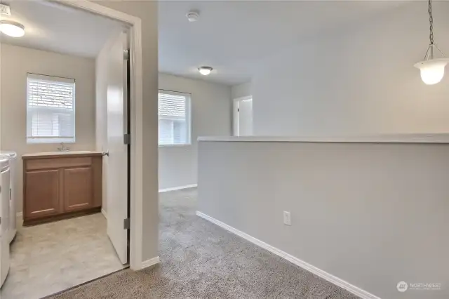 View the convenient upstairs laundry room, equipped with newer washer and dryer.
