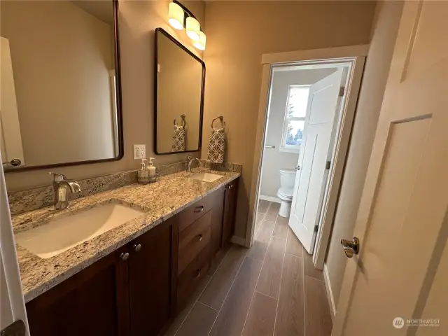 Main bath with double sinks, solid surface counters, large vanity with under mounted sinks