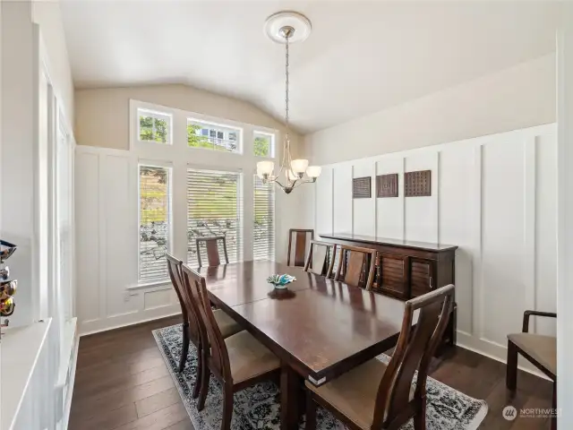 Formal Dining room with LVP flooring, customized wainscotting and high ceilings!