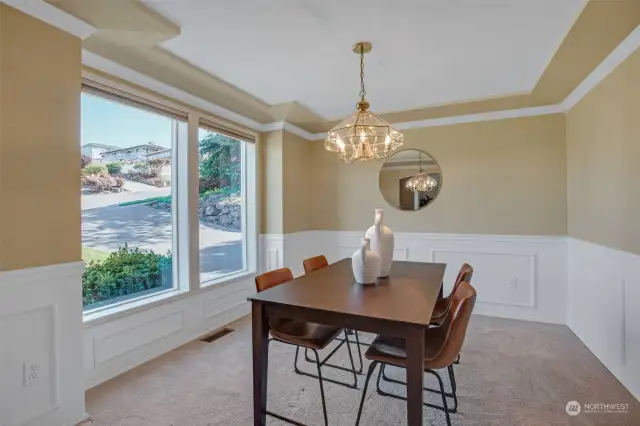 Beautiful millwork and wainscotting adorn the formal dining room.