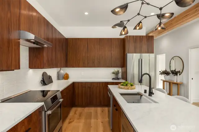 The calder inspired lighting adds a dramatic touch to this beautifully, functional kitchen!