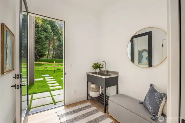 The elevated "mudroom" can serve as a coat room or add your own touches to make it a more formal secondary entryway.