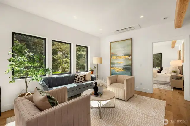 From the living area, you approach the primary suite - 10 ft ceilings and an abundance of natural light.